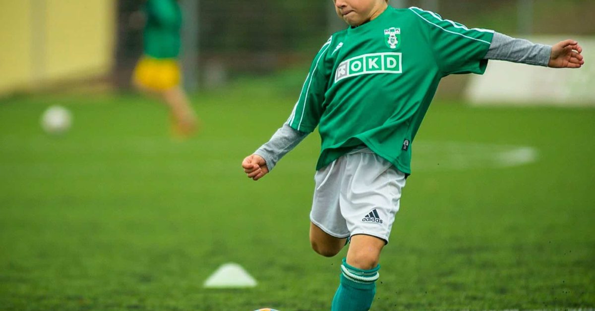 little boy playing football