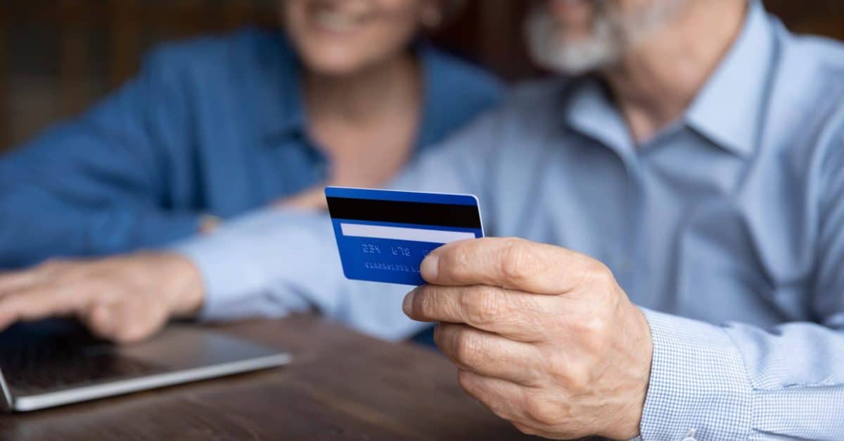 Close,Up,Mature,Man,Holding,Plastic,Credit,Card,,Senior,Couple